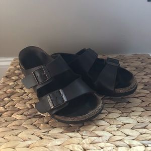 Birkenstock’s- dark brown.